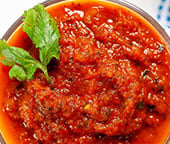 The best homemade ranchero sauce, topped with a sprig of cilantro.
