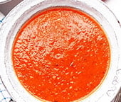 Fresh homemade tomato soup served in a white bowl.