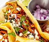 A close up side image of a chicken tinga taco.