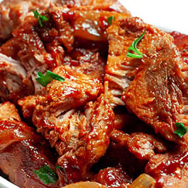 A white plate piled high with country style ribs.