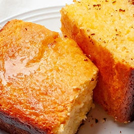 A close up image of two slices of the best Jiffy cornbread.