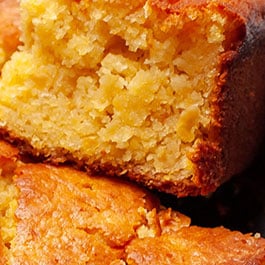 A close up image of a slice of Jiffy cornbread with creamed corn.