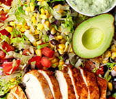Southwest chicken salad in a platter with the salad ingredients mixed together.