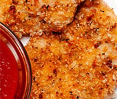 Panko chicken on a plate with a side of marinara sauce.